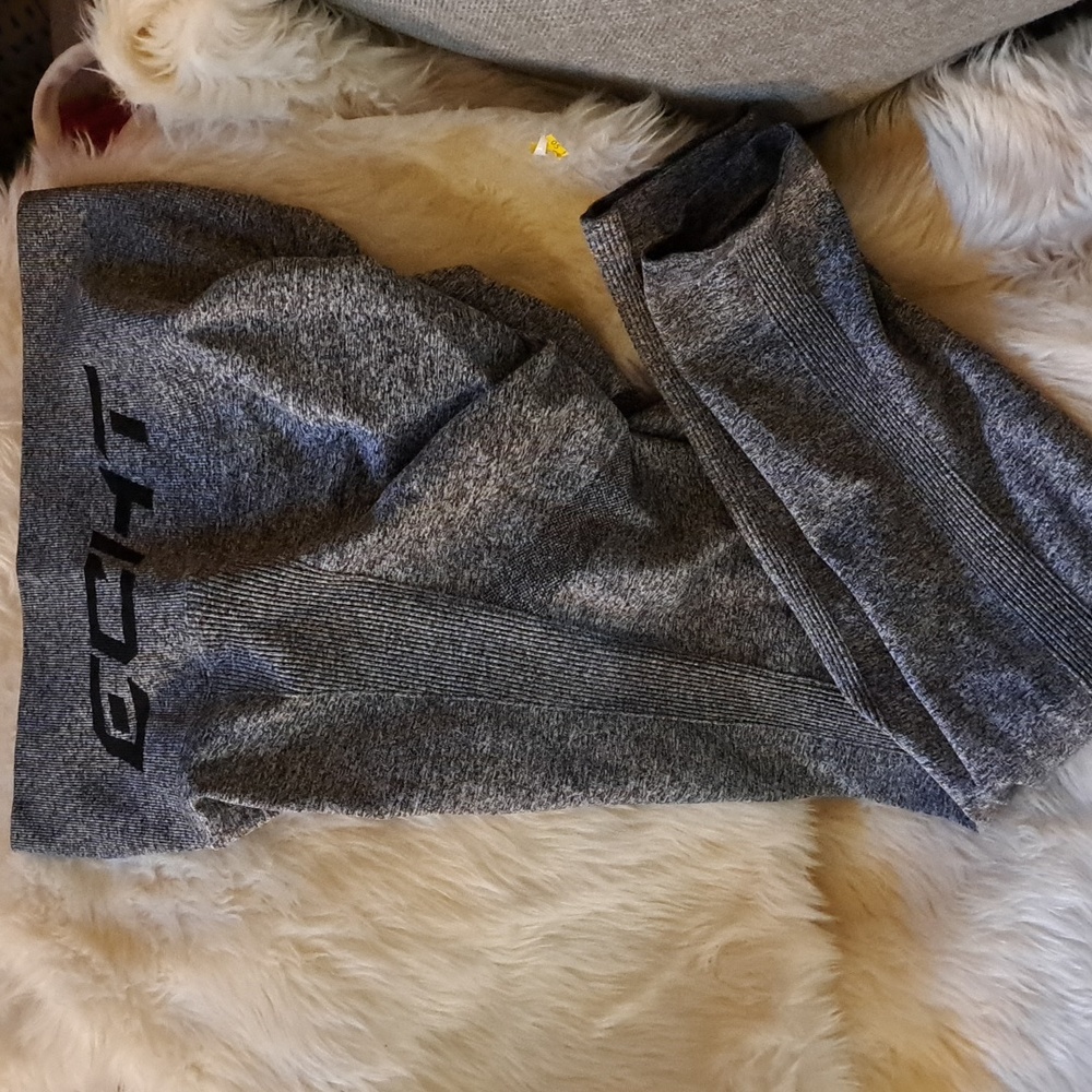 A pair of compression leggings grey and black marled